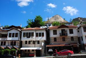 a group of buildings with a red car parked in front at Toni's Guest House in Melnik