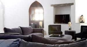 a living room with a couch and a tv at Roch Castle in Roch