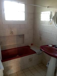 a bathroom with a red tub and a sink at La Ville de Mainguy in Josselin +58 photos