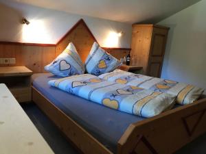 a bedroom with a large bed with a wooden headboard at Lesacherhof in Kals am Großglockner
