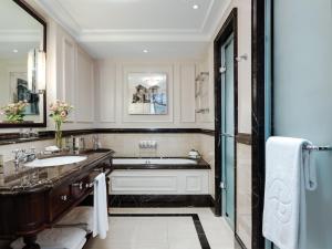 a bathroom with a tub and a sink at The Langham London in London