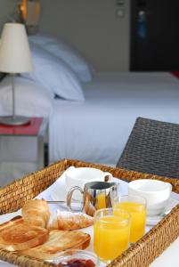 a basket of breakfast foods and drinks on a table at Grupotel Gran Via 678 in Barcelona