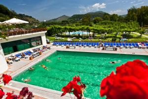 a pool with people swimming in the water at Casa Lucrino in Pozzuoli