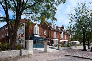 a red brick building with a blue door on a street at Hotel Cromwell Stevenage in Stevenage