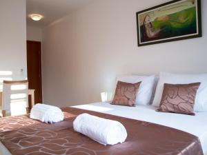 a bedroom with two beds with towels on the bed at Villa Sky in Sarajevo