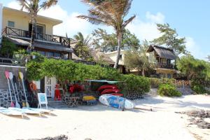 a house on the beach with surfboards on the sand at Chantauvent Guest House in Blue Bay
