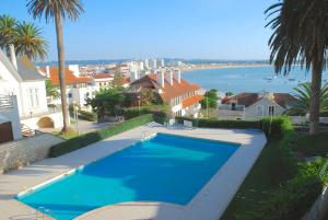 a swimming pool with a view of the ocean at Bay in São Martinho do Porto