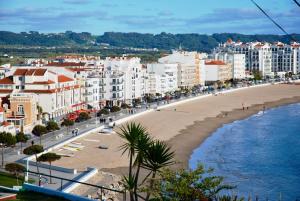 a view of a beach in a city with buildings at Bay in São Martinho do Porto
