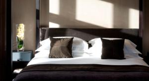 a bedroom with a bed with white sheets and pillows at Penrhiw Priory in St. Davids