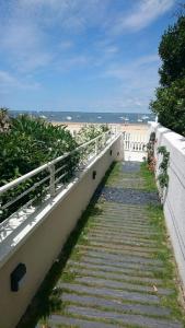 a stairway leading down to the beach with a fence at Residence vue de reve - 1 ere ligne de plage in Arcachon