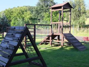 a wooden playground with a slide and a tower at Hotel Formule in Děčín
