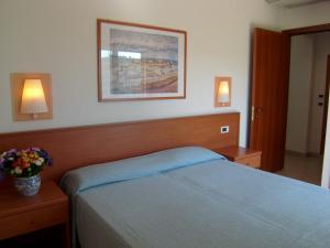 a bedroom with a blue bed with two night stands and two lamps at Residence Torre Del Mar in Alba Adriatica +45 photos