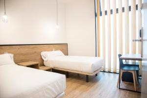 Postel nebo postele na pokoji v ubytování Somn Hipsuites Zarautz