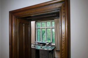 a bathroom with two sinks and a window at Penrhiw Priory in St. Davids