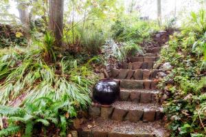 a stone staircase with a black vase on it at Penrhiw Priory in St. Davids