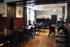a restaurant with tables and chairs and a bar at Herberg de Zwaan Hedel in Hedel