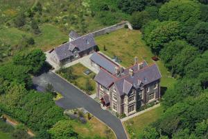 an aerial view of a large house on a hill at Penrhiw Priory in St. Davids