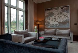 a living room with a couch and a table at Penrhiw Priory in St. Davids