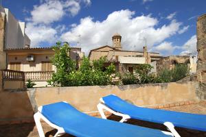 two blue and white chairs sitting on a wall at Ca'n Claret in Llucmajor
