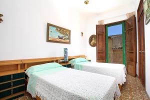 a room with two beds and a window at Ca'n Claret in Llucmajor