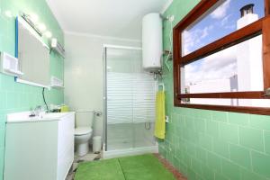 a bathroom with a toilet and a sink and a window at Ca'n Claret in Llucmajor +31 photos