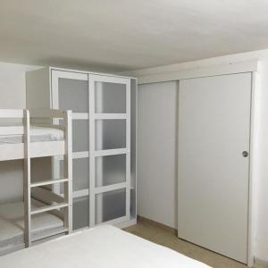 a bedroom with a bunk bed and a closet at Fresco Mare Blu in San Vito lo Capo
