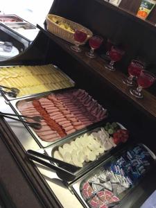 a buffet line with hot dogs and other foods at Hotel Druzba in Michalovce