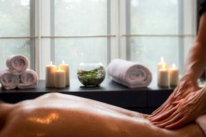a person sitting in a bath tub with candles at Penrhiw Priory in St. Davids