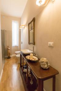 a bathroom with a sink and a mirror on the wall at Suite Royal in La Spezia