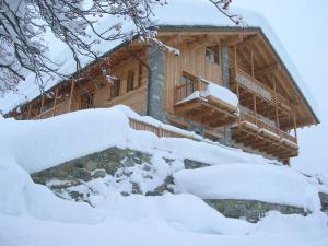 a snow covered cabin in the snow at Ellex Hotel in Gressoney-la-Trinité