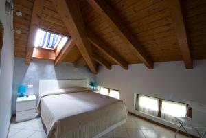 a bedroom with a bed and a wooden ceiling at Residence Royal House in Riva del Garda