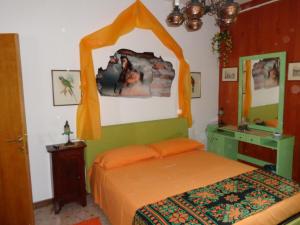 a bedroom with a bed with an orange canopy at B&B Villa Tina in Alfedena