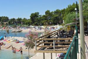 a beach with a bunch of people in the water at Apartment Tina in Split