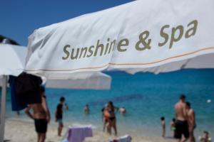 a group of people on a beach with the ocean at Sunshine Club Hotel Centro Benessere in Ricadi