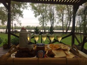 a table topped with glasses of wine and food at MauMari in Tigre +29 photos