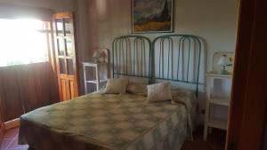 a bedroom with a bed with a green headboard at Casa Vacanze Arenella in Arenella