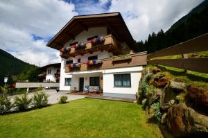 a house with a balcony with flowers on it at Appartement Bergblick in Neustift im Stubaital