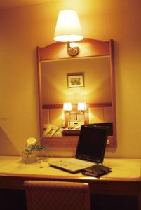 a laptop computer sitting on a desk in front of a mirror at Shibushiwan Daikoku Resort Hotel in Shibushi