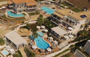 an aerial view of a mansion with a swimming pool at Delfino Blu Wellness Boutique Hotel in Agios Stefanos
