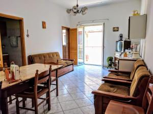 a living room with a table and a couch at 24 Cannoli in Leonforte
