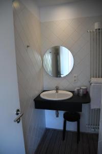 a bathroom with a sink and a mirror at L'Auberge Saint Remacle in Stavelot