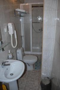 a bathroom with a toilet and a shower and a sink at Hotel Jagielloński in Sanok