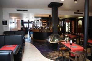 a restaurant with tables and chairs and a fireplace at L'Auberge Saint Remacle in Stavelot +6 photos