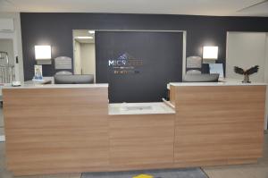 a room with a white wall and a black counter top at Microtel Inn and Suites by Wyndham Lubbock in Lubbock