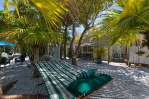 a green hammock on the beach with palm trees at Tarpon Tale Inn in Sanibel