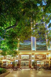 a large building with benches in front of it at Conifer Boutique Hotel in Hanoi