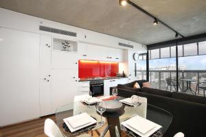 a living room with a couch and a table at StayCentral - NGV Arts Centre Retreat Southbank in Melbourne