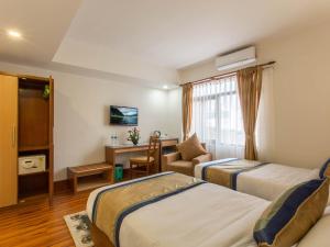 Letto o letti in una camera di Oasis Kathmandu Hotel
