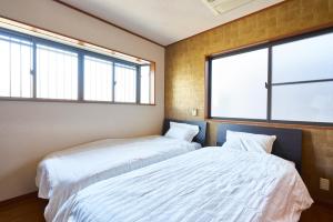 Postel nebo postele na pokoji v ubytování Guesthouse Nijo Fukuro-Tei