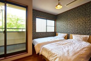 Postel nebo postele na pokoji v ubytování Guesthouse Nijo Fukuro-Tei